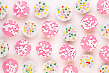 Colorful cupcakes on a white background.