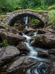A packhorse bridge crossing a tributary below a waterfall on the south bank of the River Lyon. This is locally known as the Roman Bridge, though actually seems to date back to the 1600s or 1700s.