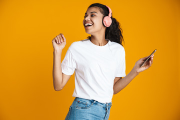 Image of happy african american woman smiling and using mobile phone