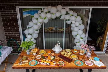 First Anniversary Party. Balloons, food and cake for children's birthday. The first birthday of the baby. Modern Vintage Decor for children's birthday. Birthday party concept.