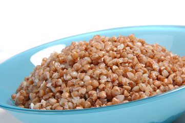 groats in plate on white