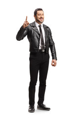 Full length portrait of a young man in a leather jacket pointing up