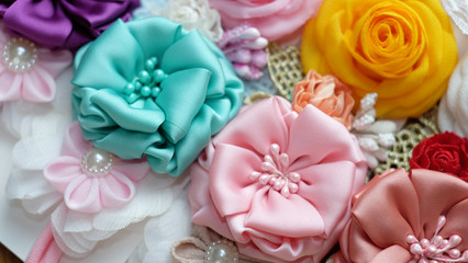 Obraz na płótnie Canvas A bouquet of flowers made out of fabric cloth textile in beautiful pastel colors that can be used as hair accessory, decoration, and embellishment