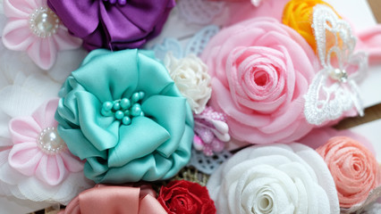 A bouquet of flowers made out of fabric cloth textile in beautiful pastel colors that can be used as hair accessory, decoration, and embellishment