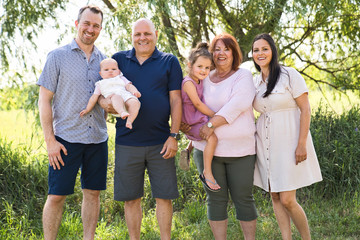 family relaxing together in nature with grandparent