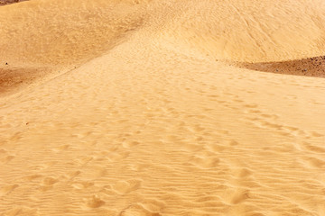 Footprints in the sandy desert. Texture background travel concept