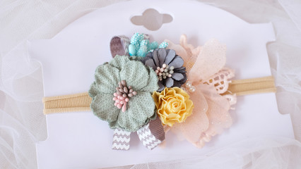 A bouquet of flowers made out of fabric cloth textile in beautiful pastel colors placed on card stock paper that can be used as hair accessory, decoration, and embellishment
