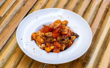 Homemade cavatelli pasta with sauce puttanesca
