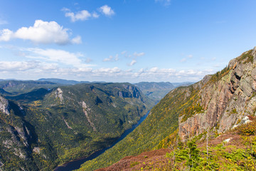 Naklejka premium view from the top of a cliff in summer with a green valley below