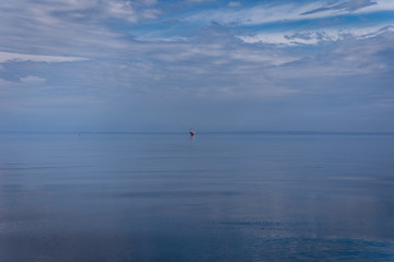 Fototapeta premium same tones of blue water and sky with no visible shore