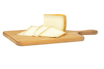Isolated Heidi goat cheese on a wooden Board with red pepper and walnuts with clipping path on white background