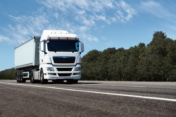 truck on the road, front view, empty space on a white container - concept of cargo transportation,...