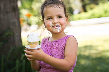 Portrait of young happy girl eating ice-cream