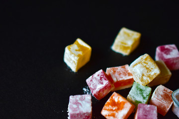 Delicious Oriental sweets Turkish delight on a black background