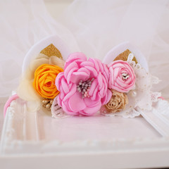 A bouquet of flowers made out of fabric cloth textile in beautiful pastel colors with cat ears design as hair accessory, decoration, and embellishment