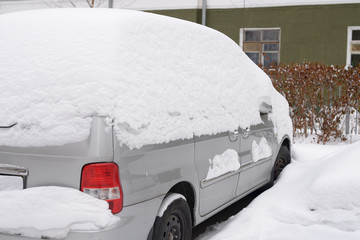 Car under snow. Snowy winter