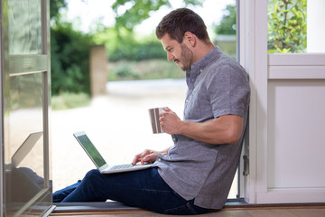 Businessman Working From Home On Laptop During Pandemic Lockdown