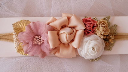 Fototapeta na wymiar A bouquet of flowers made out of fabric cloth textile in beautiful pastel colors that can be used as hair accessory, decoration, and embellishment