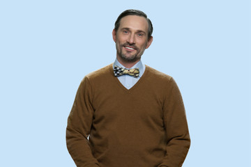 Handsome mature man looking at camera. Portrait of elegant caucasian man looking at camera with a smile on color background.