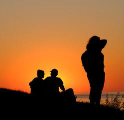 Group people on background of empty sunset beach. Europe. 14.08.2020