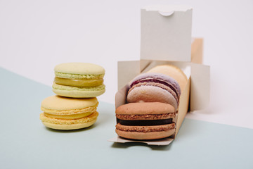 Several colorful macaroon cakes on a colored background