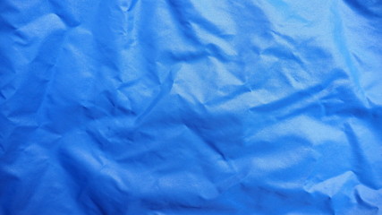 Obraz premium Top view of crumpled bright dark blue nylon fabric for background and decoration