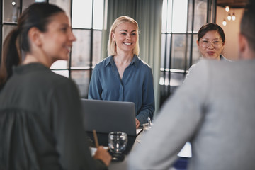 Smiling office colleagues talking together during a meeting