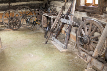 Plakat old parts of a wagon inside an old building