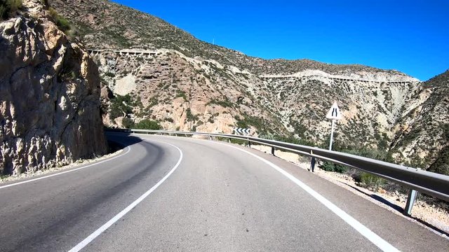 POV Spanish mountain drive on a sunny day, descending.