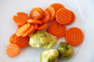 steamed Brussels sprouts and carrots close up