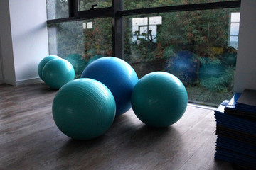 Naklejka na ściany i meble fitness balls by the window in the gym close up