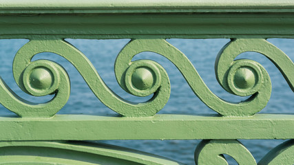 Abstract forged architectural detail of bridge fence painted with green paint