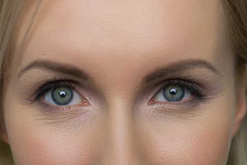 Close up female face with beautiful blue eyes. Close up eyes of a beautiful woman.