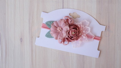 A bouquet of flowers made out of fabric cloth textile in beautiful soft pastel pink theme colors placed on cardstock paper that can be used as hair accessory, decoration, and embellishment