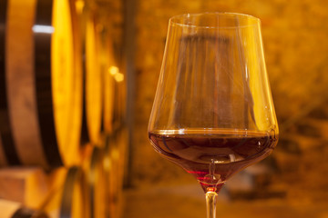 Close-up a glass with red wine in a wine cellar