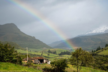 Beutiful natural landscape with a snowny mountain in the background with a amazing raimbow in the sky