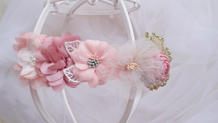 Handmade flower made out of fabric cloth textile in beautiful soft pastel pink theme colors that can be used as hair accessory, decoration, and embellishment