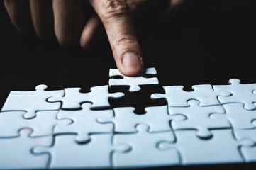 Teamwork of partners, concept of integration and startup with puzzle pieces