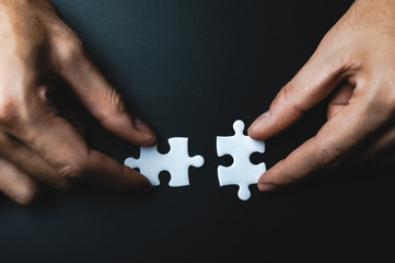 Teamwork of partners, concept of integration and startup with puzzle pieces
