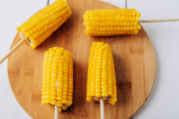 Boiled corn on a white wooden natural background