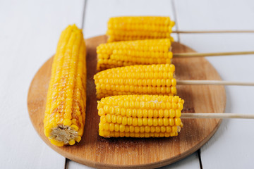 Boiled corn on a white wooden natural background