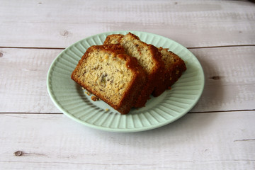 Freshly baked banana cake on a plate on a wooden table