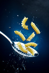 fusilli pasta on a spoon, advertising photo