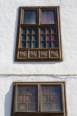 Brown windows in white wall