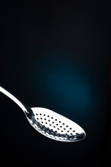 just spoon skimmer on dark background