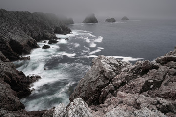 Fog at pointe de Pen-Hir on Cap de Crozon, Finistère, Bretagne / Brittany. Beautiful rough landscape of cliffs and waves in France. 
