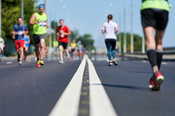 Runners on city road.