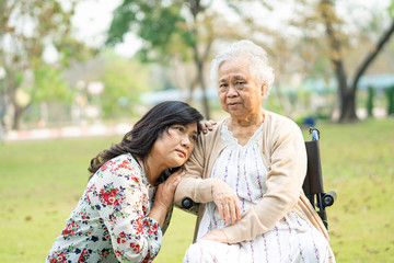 Asian senior or elderly old lady woman patient on wheelchair in park, healthy strong medical concept.