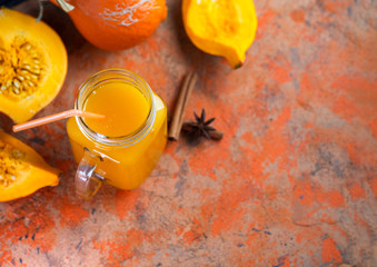 Fototapeta na wymiar Can of natural homemade pumpkin juice or smoothies on the table with cinnamon, anise