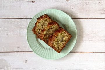 Freshly baked banana cake on a plate on a wooden table